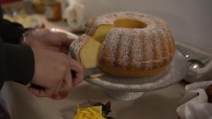 a person cutting a cake on a table at Tenuta Santa Rosa in Sannicola