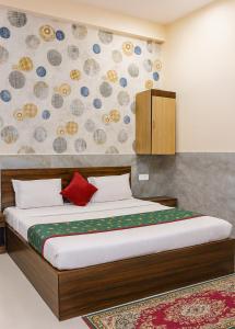 a bedroom with a large bed with a red pillow at Hotel Royale Elite RK Residency in Vrindāvan +22 photos