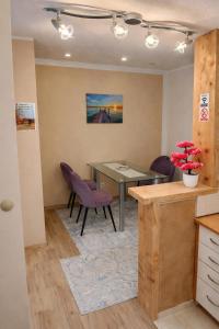 a dining room with a table and purple chairs at Sarajevo Old Town 1 Free Parking & RoofTop View in Sarajevo