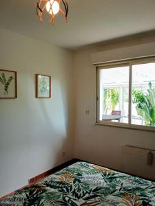 a bedroom with a bed and a window at Gite d'Ossau in Lescar +8 photos