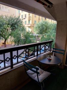 a balcony with a table and two chairs and a window at Menton 1 in Menton