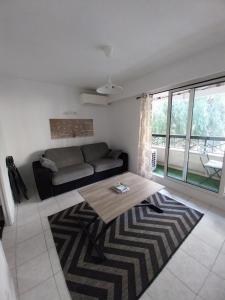 a living room with a couch and a table at Menton 1 in Menton