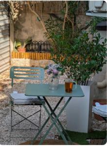 a table and a chair with a vase on it at La Perle in Marseille