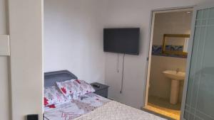 a bedroom with a bed and a television on the wall at Ivan John Guest home in Number Two Village +22 photos
