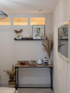 a room with a table and a shelf with pictures at La Perle in Marseille