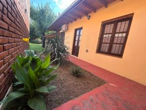 a house with a brick wall and a brick walkway at Hosteria Telen in Telén