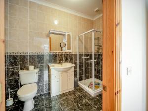 a bathroom with a toilet and a sink and a shower at 3 Bed in Renvyle oc-i254 in Cashleen +14 photos