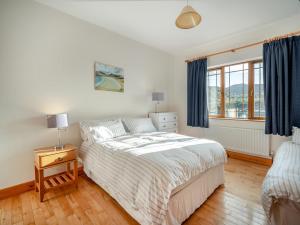 a white bedroom with a bed and a window at 3 Bed in Renvyle oc-i254 in Cashleen
