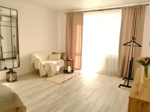 a white room with a bed and a mirror at Comfort House Партизанська 25 in Bila Tserkva