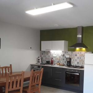 a kitchen with a table and a stove top oven at Chez René in Montagnac