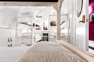 a bedroom with two bunk beds and a room with at Old Town Hostel in Stockholm