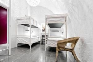 a bedroom with two bunk beds and a chair at Old Town Hostel in Stockholm