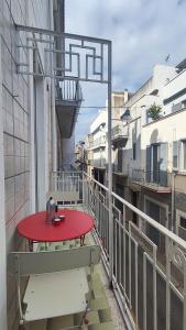 a red table on the balcony of a building at Convers'Amo Home in Conversano