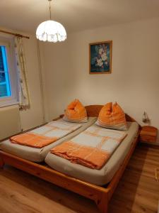 two twin beds in a bedroom with a chandelier at Ferienhaus Wohleser in Mariahof +74 photos