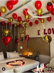 a room with red and gold balloons and a bed at Hotel Pallavi Grand in Panchkula