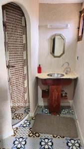 a bathroom with a sink and a shower with a mirror at Tizi Maison d'Hôtes in Telouet +63 photos