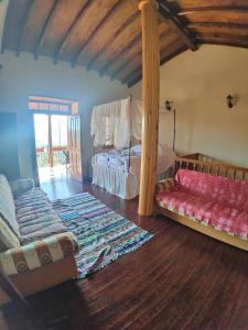 a bedroom with a bed and a couch in a room at Archontikon 1817 in Kaliana