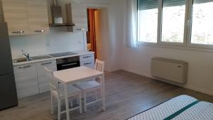 a kitchen with a table and a small table and chairs at Guest House Il Colibri' in Bologna +16 photos