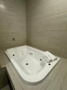 a large white bath tub in a bathroom at Hotel Taxaha in Candelaria +17 photos