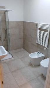 a bathroom with a shower and a toilet and a sink at Guest House Il Colibri' in Bologna