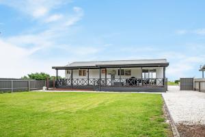 a house with a large lawn in front of it at Adrift - Oceanfront - Pets Welcome in Middleton