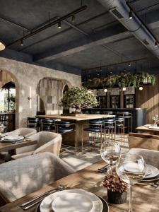 a restaurant with tables and chairs and a bar at Hotel Centar Sanski Most in Sanski most