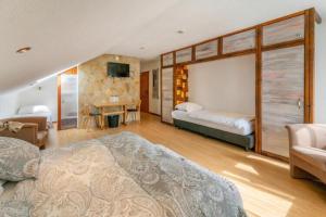 a bedroom with two beds and a tv in it at Belvilla Heiderhof in Rheinischen Westerwald in Obersteinebach +90 photos