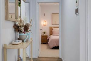 a bedroom with a bed and a table with a table sidx sidx sidx at Allawah in Encounter Bay