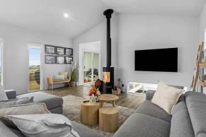 a living room with a couch and a fireplace at Allawah in Encounter Bay