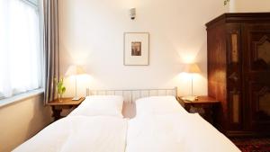 Ein Bett oder Betten in einem Zimmer der Unterkunft Altstadt Gästehaus Drewes Wale