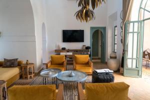 a living room with a couch and a table at Villa Riad Marrakech in Najem