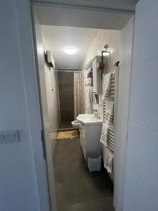 a bathroom with a sink and a toilet and a shower at Apartman Ćorić in Kiseljak