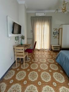 a bedroom with a desk and a bed and a table at Donna Felì in Gragnano