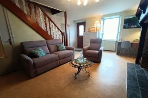 a living room with a couch and a table at La bellevue in Lapeyrugue