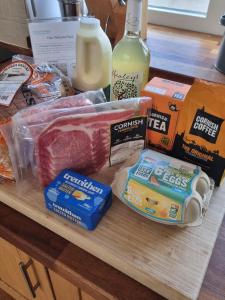 a table with meat and other food items on it at Heather Barn in Saltash