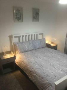 a bedroom with a bed with two nightstands and two lamps at Gorgeous Marina 2 Bed Apartment in Portishead