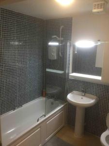 a bathroom with a sink and a tub and a toilet at Gorgeous Marina 2 Bed Apartment in Portishead