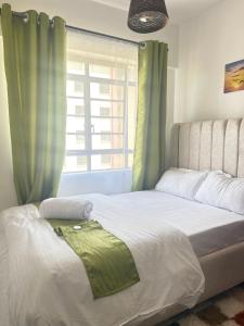 a bedroom with a large bed with a window at Gated executive 1 bed in gated near Top Malls, Kisumu in Kisumu