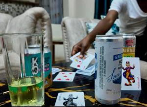 a table with a glass of water and playing cards at Gated executive 1 bed in gated near Top Malls, Kisumu in Kisumu