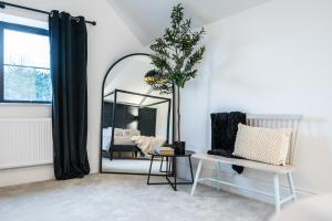 a room with a mirror and a chair and a bed at No 4 The Halesworth in Halesworth