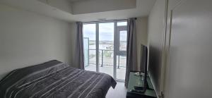 a bedroom with a bed and a large window at Corner unit 3 bath and 2 bed in Vaughan