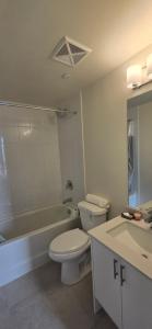a bathroom with a toilet and a tub and a sink at Corner unit 3 bath and 2 bed in Vaughan +14 photos