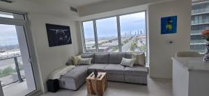a living room with a couch and large windows at Corner unit 3 bath and 2 bed in Vaughan