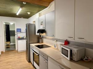 a kitchen with a sink and a microwave at Downtown Apartments in Interlaken
