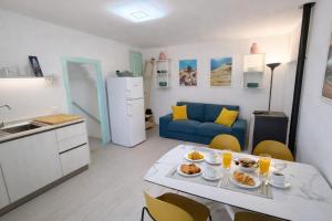 a kitchen and living room with a table with food on it at Casa Tiffany - Elba Affitti in Rio nellʼElba