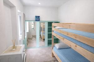 a room with a bunk bed and a mirror at Casa Tiffany - Elba Affitti in Rio nellʼElba