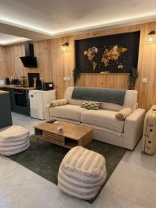 a living room with a couch and a coffee table at Studio chaleureux, massage, terrasse privé, barbecue et balneo in Cussac-Fort-Medoc