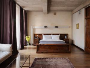 a bedroom with a large bed and a couch at Hotel Stary in Krakow