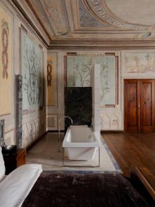 a bathroom with a bath tub in a room at Hotel Stary in Krakow