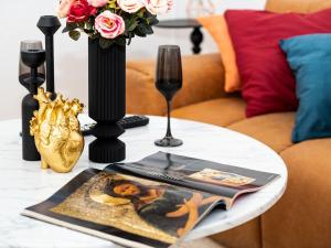 a table with a book and a glass of wine on it at Altstadt Geverdes 1 in Lübeck